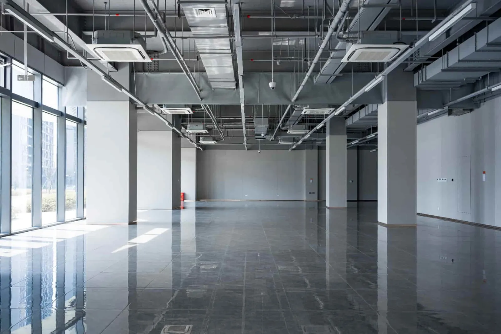 Open-plan commercial office with ceiling cassette air conditioning and exposed ductwork