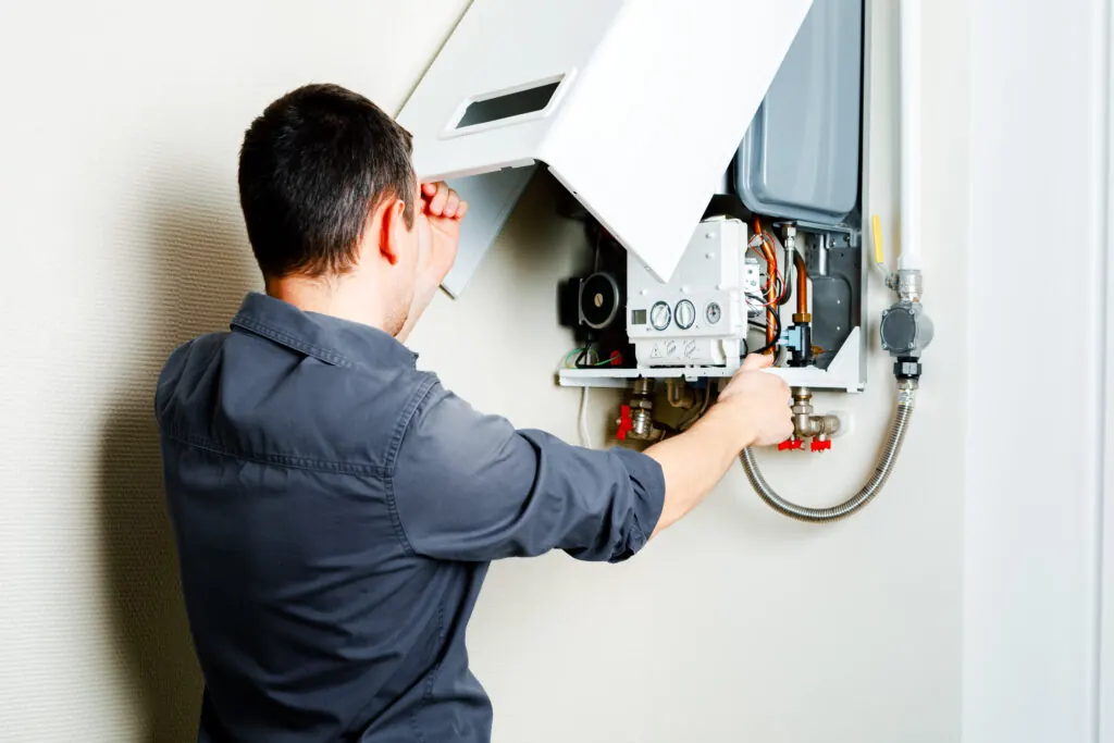 Gas Safe engineer servicing older boiler not working at peak efficiency due to age
