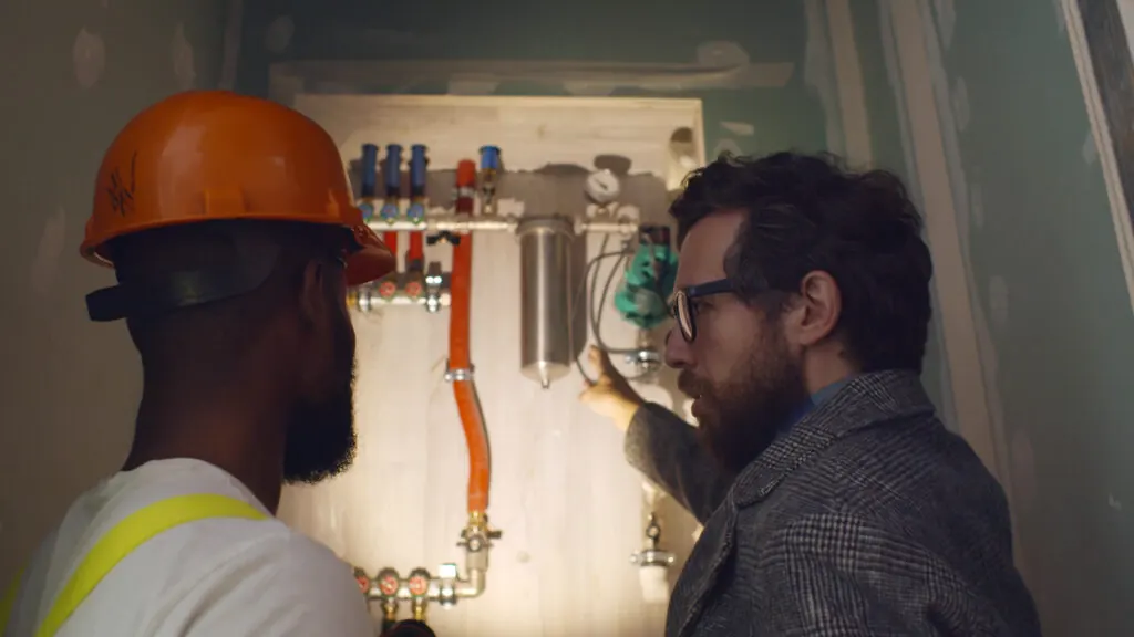 engineer explaining new boiler to homeowner