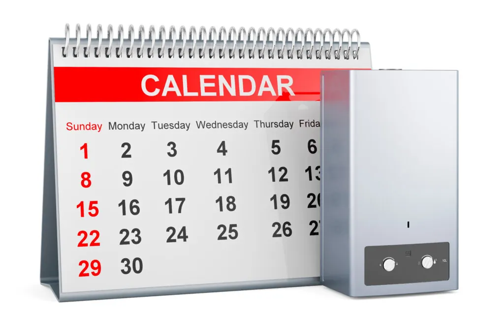 Desktop calendar showing monthly schedule beside modern gas boiler control panel for landlord gas safety planning in Scotland