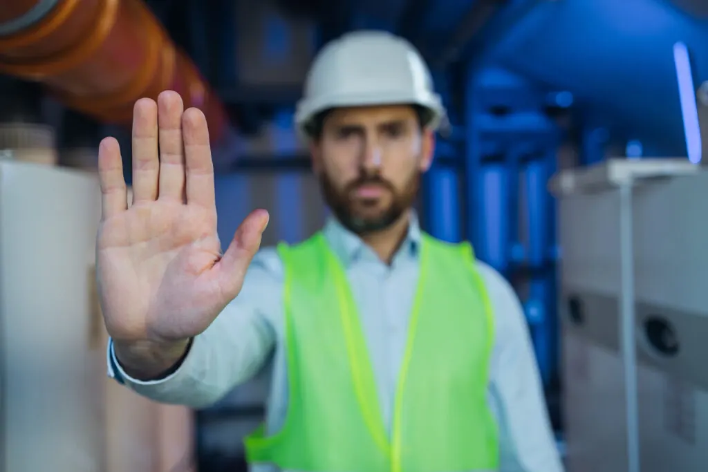  Worker gesturing stop sign in technical room