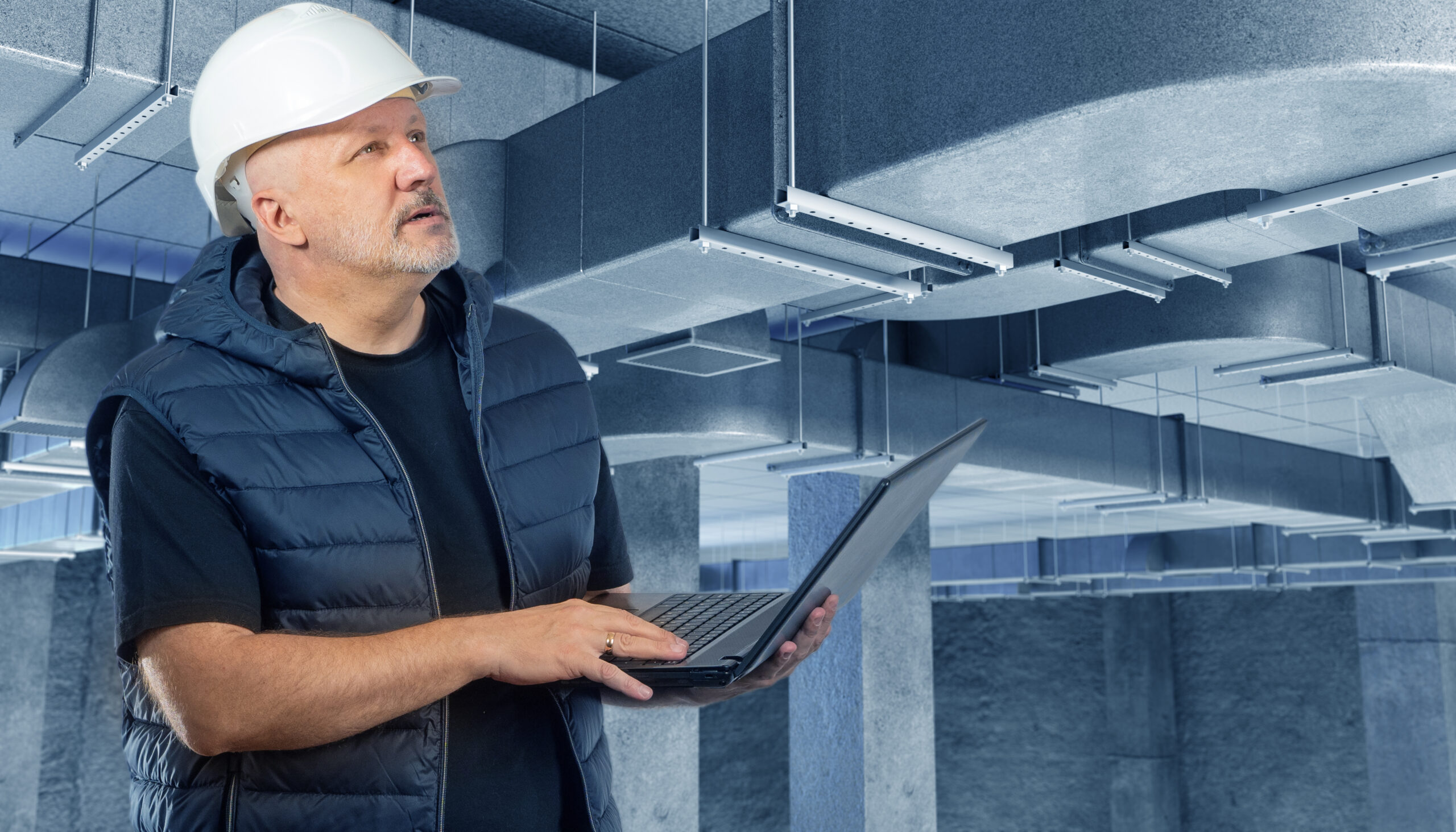 Engineer inspecting commercial HVAC systems for commercial boiler service compliance in Scottish business property
