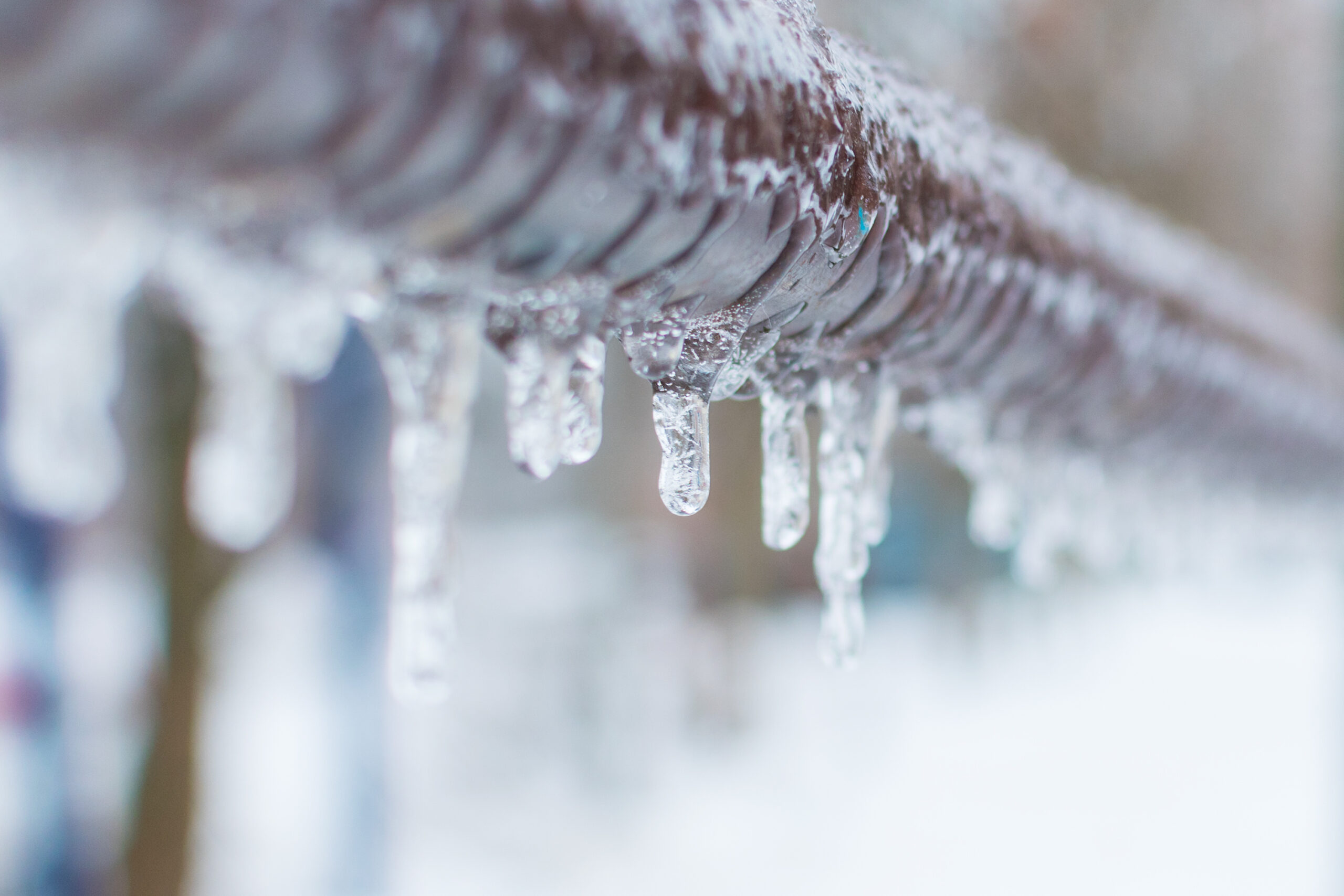 Ice forming on boiler condensate pipe showing signs of boiler problems in winter