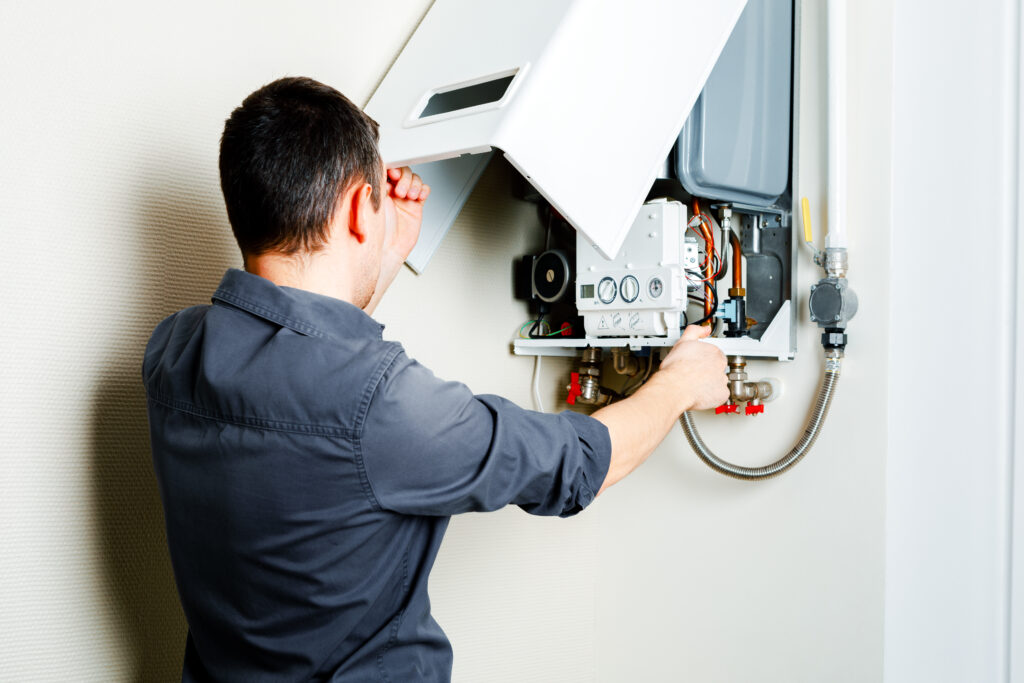 Gas Safe engineer servicing older boiler not working at peak efficiency due to age"