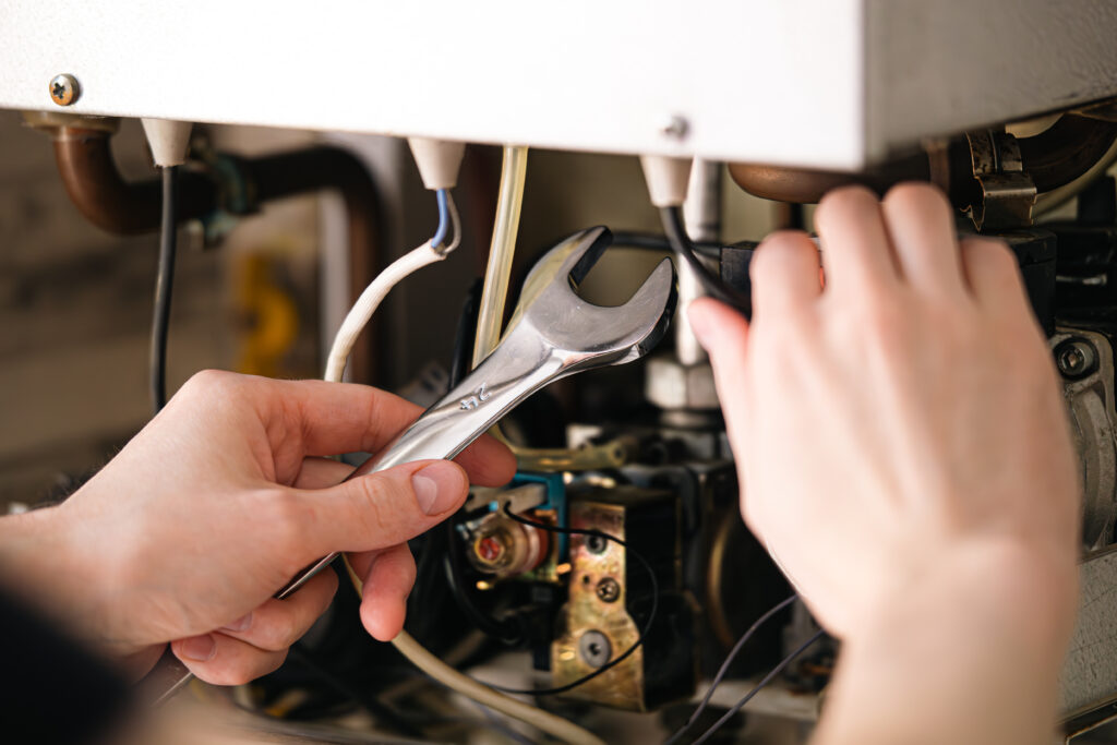 Pair of hand working on a boiler service