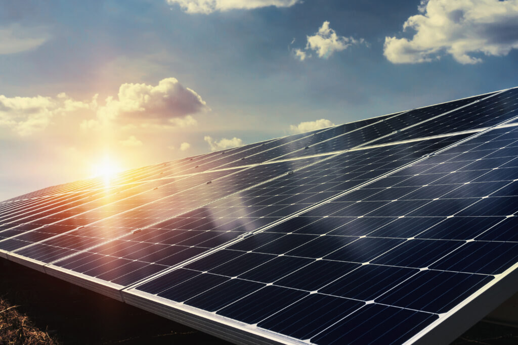 Solar panel with sunlight and blue sky background. 